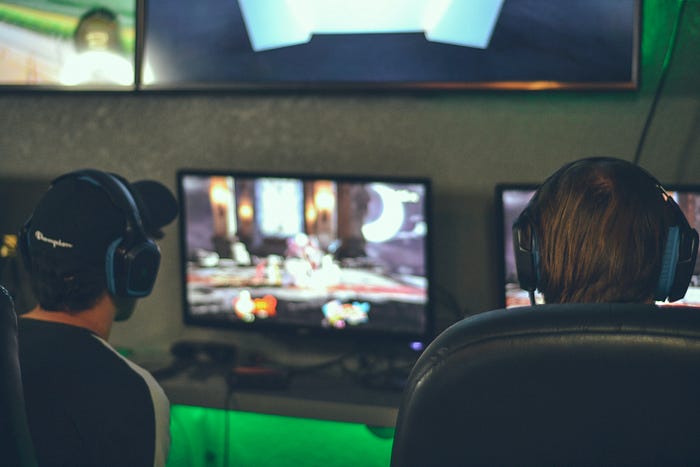 Two boys playing video games on their computers